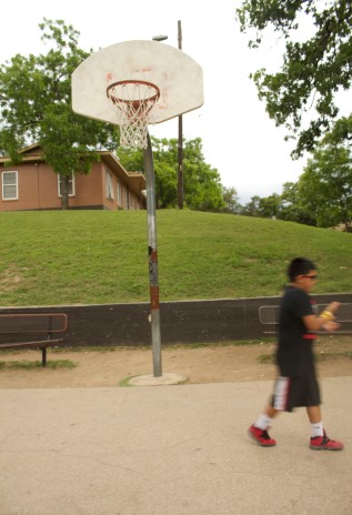 Resident of Rosewood Courts playing basketball on May 5, 2015 in Austin, Texas.