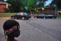 Marleya Silas, a resident of Rosewood Courts watching other residents sit outside on May 5, 2015 in Austin, Texas.