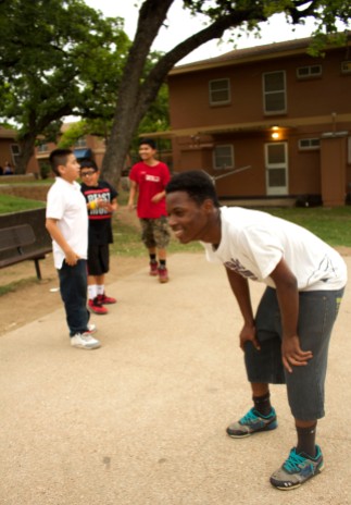 Boys who live at Rosewood Courts play a game of basketball on May 5, 2015 in Austin, Texas.