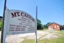 Mt. Calvary Missionary Baptist Church sign and an empty church in the background on April 18, 2015.
